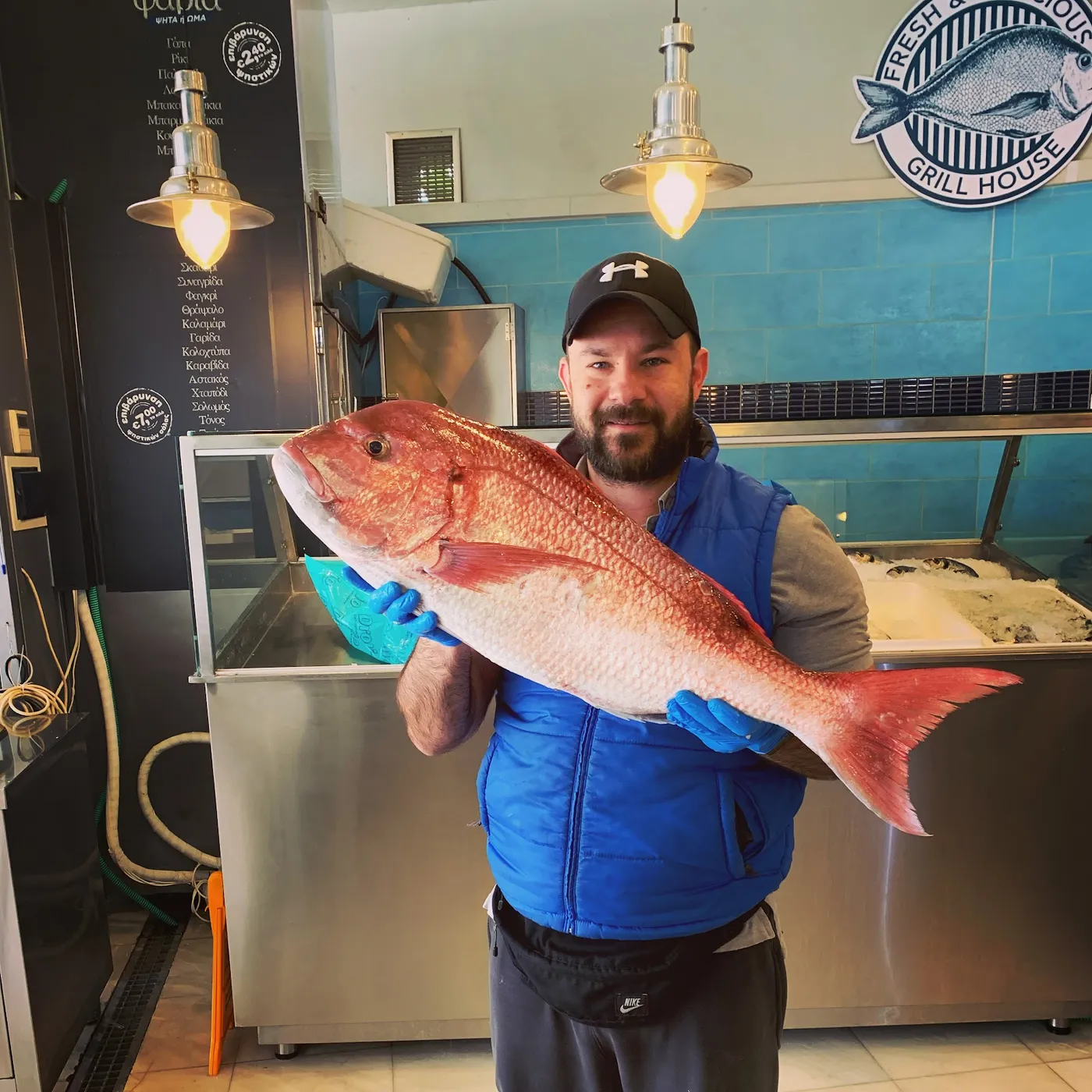 Our fishmonger holding the day's fresh catch