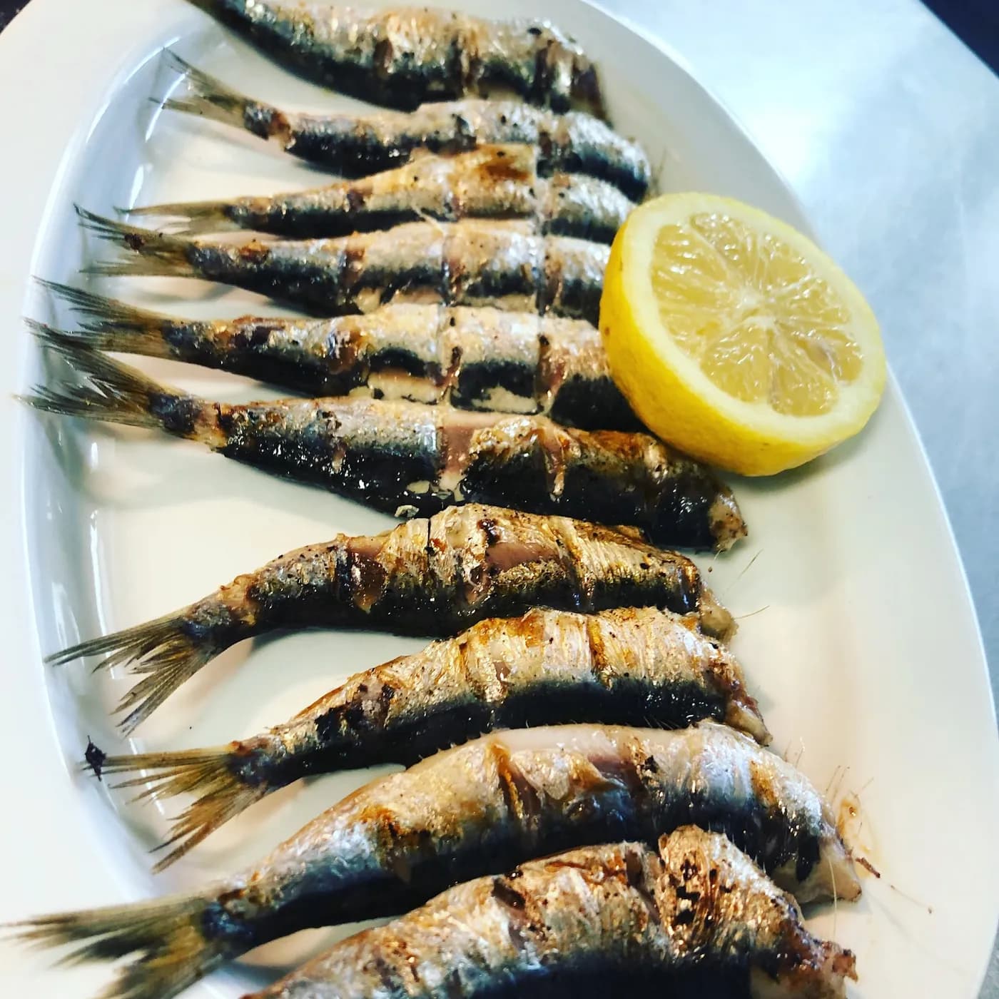 Sardines grilled over charcoal with lemon